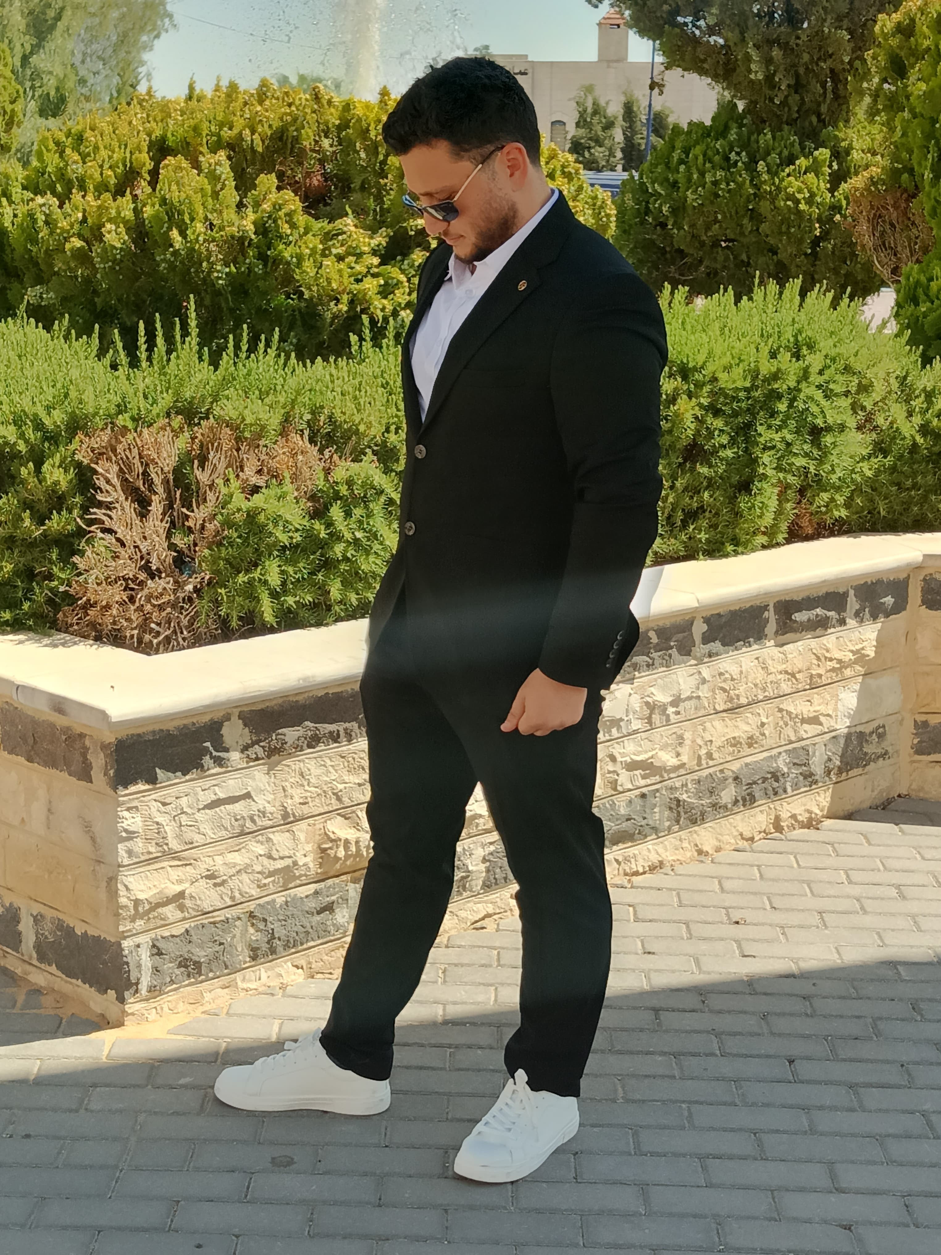 ["shoes","sidewalk","suit","man"]