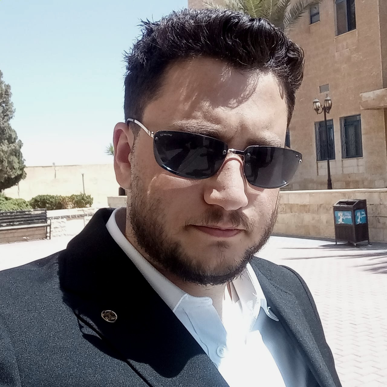 ["sunglasses","suit","jacket","man"]