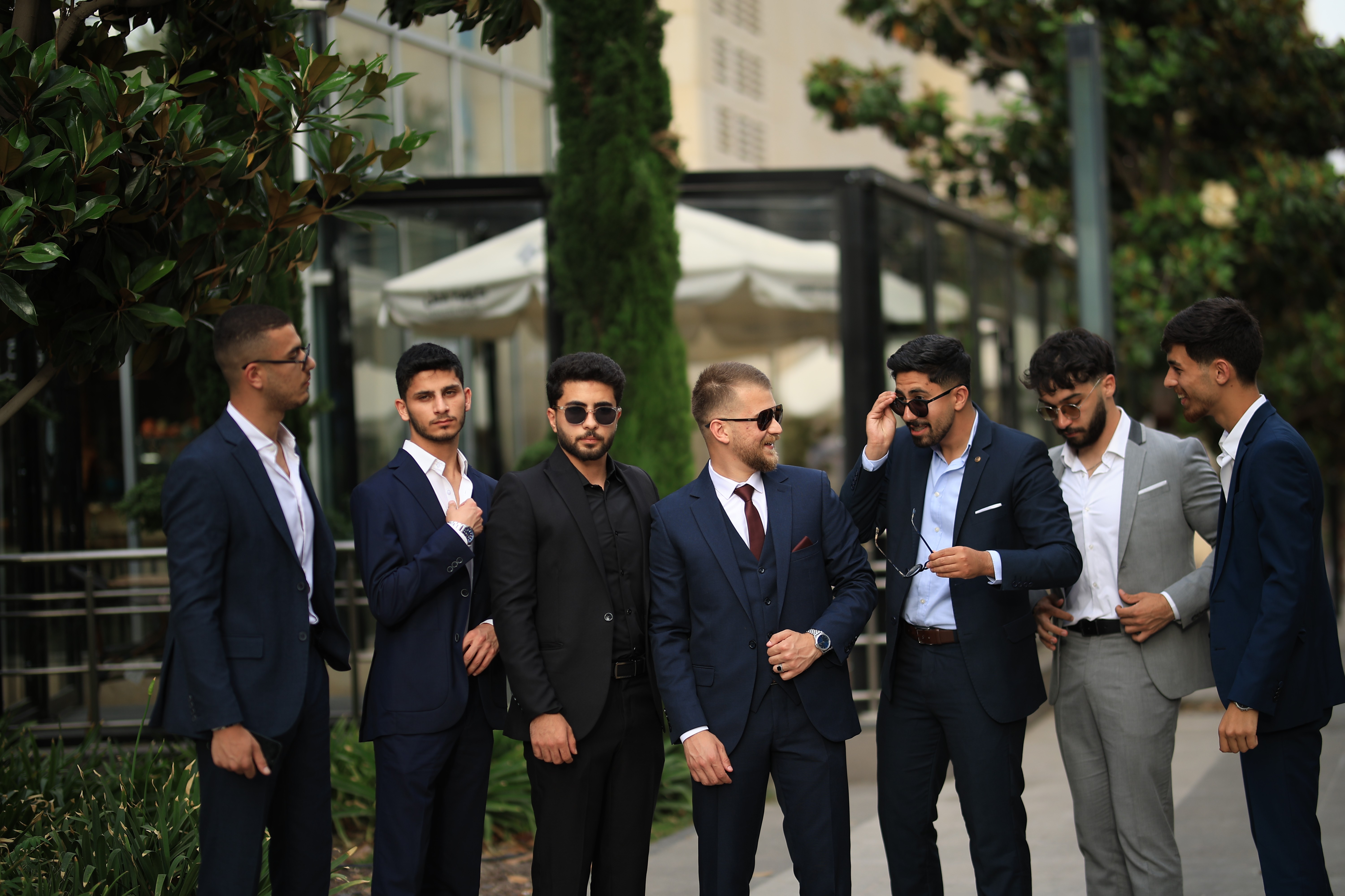 ["men","suits","group","ties"]